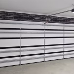 Interior view of a sectional garage door installation with insulation and an automatic opener motor in a Shepparton home.